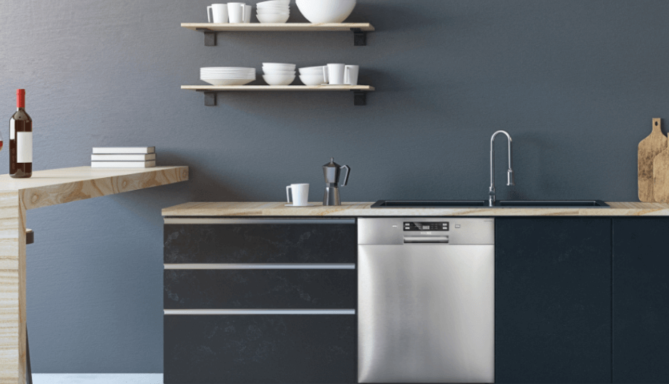 A modern kitchen counter with large KOENIC household appliances and a washing machine and sink in a kitchen, panorama